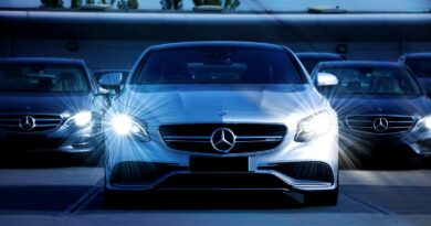 Front view of a lineup of Mercedes-Benz cars with bright headlights, showcasing luxury and elegance.