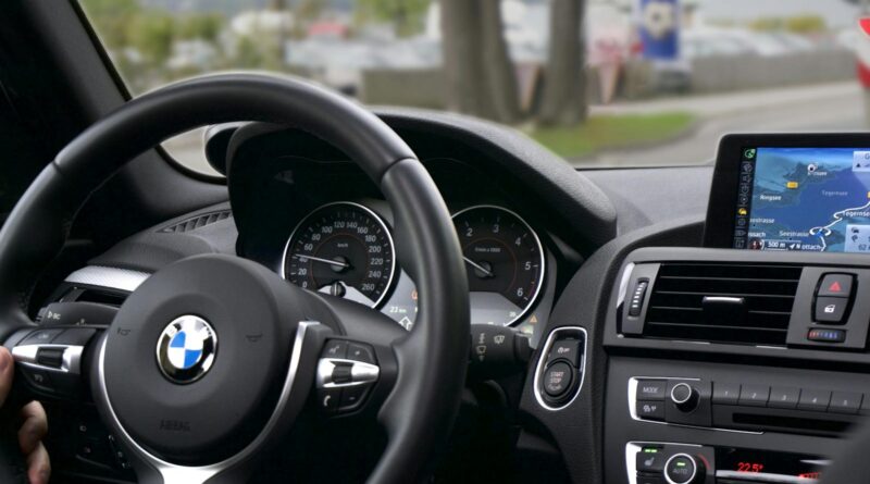 Elegant BMW car interior showcasing navigation screen, speedometer, and steering wheel.